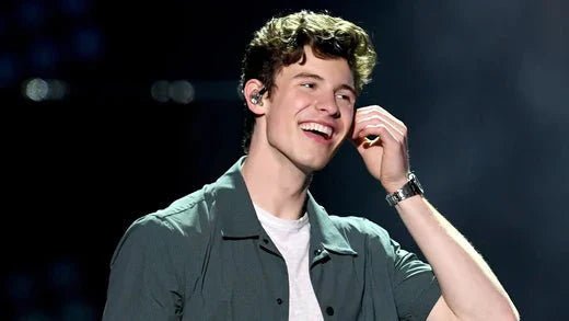 Shawn Mendes Smiling in the direction of his audience.